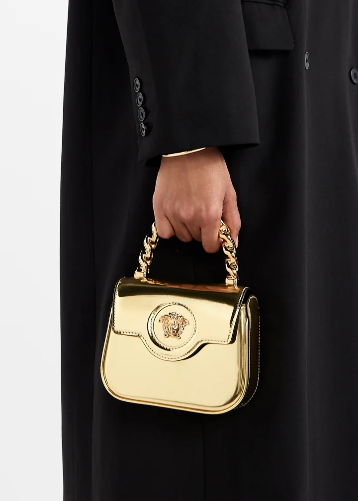 The gold La Medusa mini carried by hand